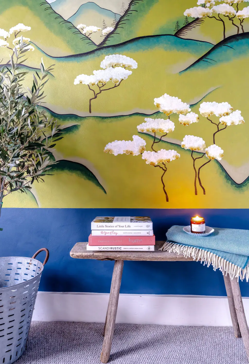 Playful Japanese-inspired landscape mural with mountains, fields, and trees in a flat graphic style.