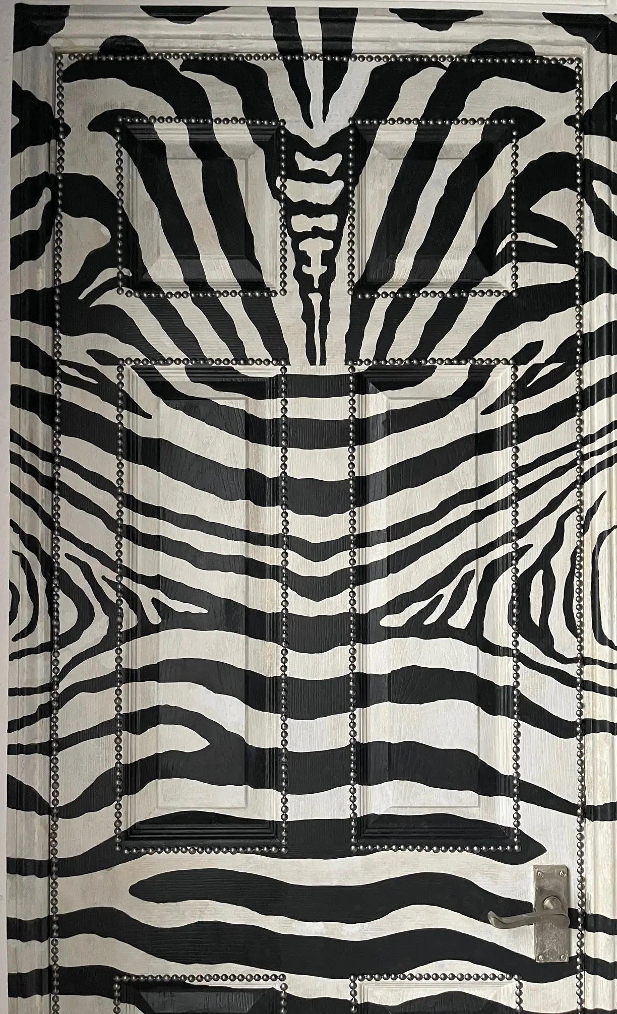 Zebra mural creating a sense of movement and energy on a door